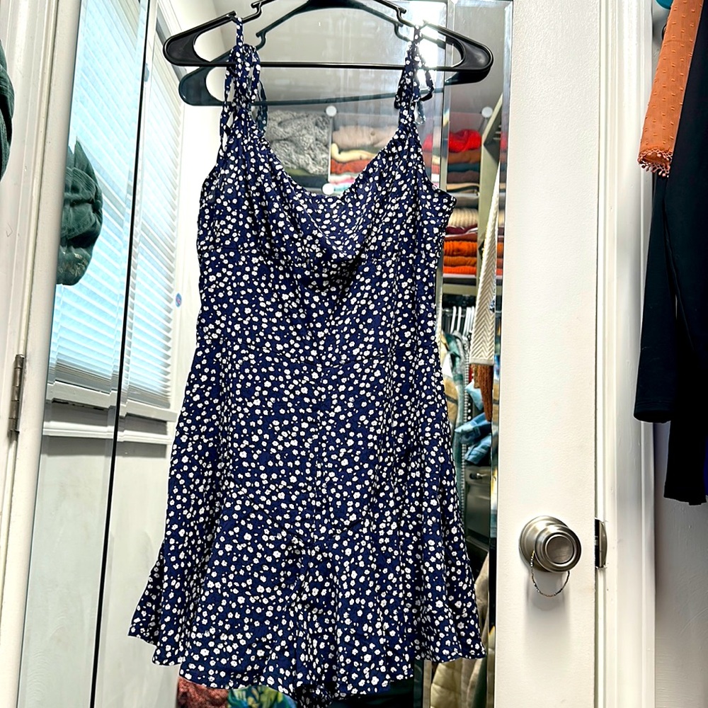 Medium navy blue and white flowy romper. Tie straps. Zipper back. Never worn